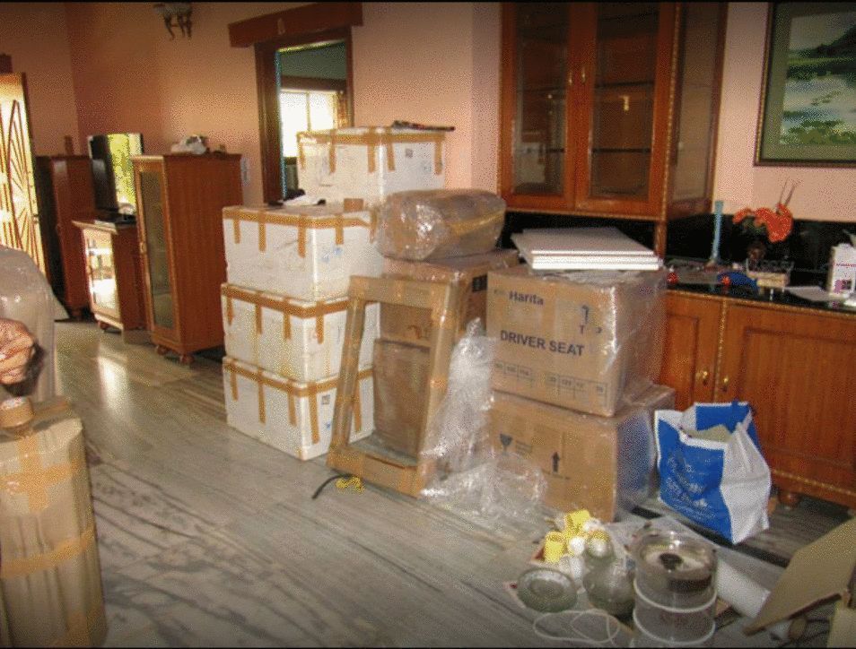 Relocation boxes and furniture packed in living room