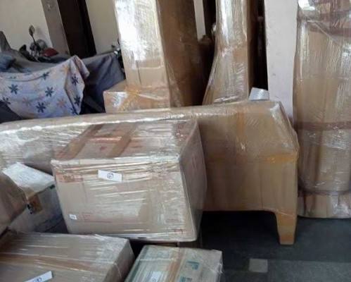Wrapped furniture and moving boxes inside home